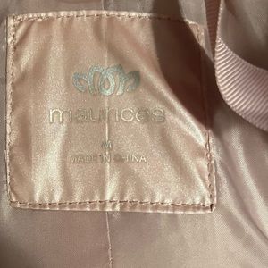 It’s a rose gold puffy silk vest. It’s brand new. Does not a have a tag though.